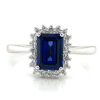 14ct White Gold Laboratory Grown Emerald Cut 1.10ct Sapphire and 0.15ct Diamond Halo Ring