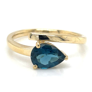 A 9ct yellow gold ring with a pear cut London Blue Topaz gemstone.