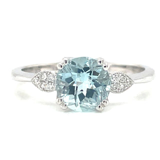 white gold gemstone ring with aquamarine central stone and side diamonds