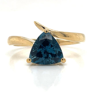 A trillion cut London blue topaz gemstone ring with 9ct yellow gold band