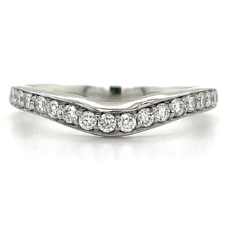 A platinum band ring with earth grown diamonds set in a channel design, displaying a curved pattern.