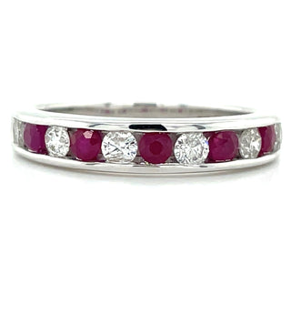 A 9ct white gold ring with a channel setting featuring alternating ruby and diamond stones.