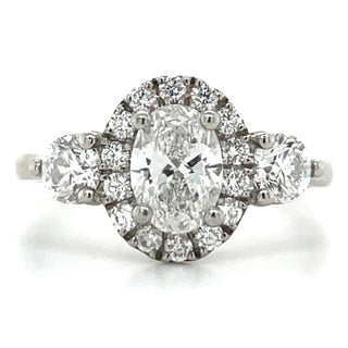 Platinum Oval halo three stone diamond engagement ring with round diamond side stones