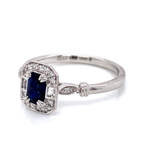 .60ct Navy Emerald Cut Sapphire Ring with White Sapphire & Diamond Mounting.
